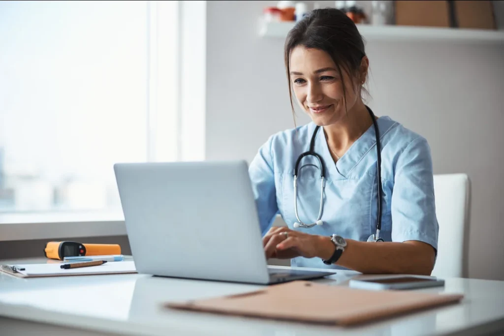 nurse-scrubs-working-laptop-clinic